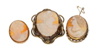 THREE CARVED CAMEO BROOCHES, each with a profile of a lady, mounted in unmarked metal mounts,
