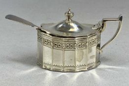 VICTORIAN SILVER MUSTARD POT, of panelled oval form, with hinged cover, blue glass liner, and spoon,