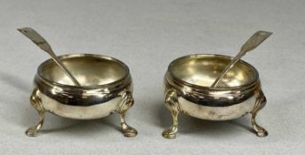 TWO GEORGIAN CIRCULAR SILVER OPEN SALTS, on hoof feet, hallmarks rubbed, 6cms (diam.); a Georgian
