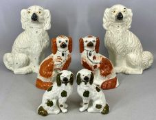 THREE PAIRS OF 19TH CENTURY STAFFORDSHIRE SEATED SPANIELS, cream with black muzzles, 35cms (h),