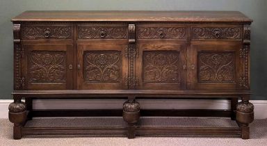FINE EDWARDIAN CARVED OAK SIDEBOARD, four drawers over four cupboard doors, on bulbous and block