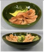 MOORCROFT GREEN MAGNOLIA FOOTED FRUIT BOWL, with Queen Mary label, 26cms (diam.); and a similar