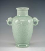 CHINESE CELADON GLAZED PORCELAIN VASE, moulded with stylised lotus and elephant head handles,