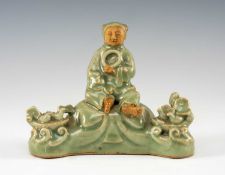 CHINESE LONGQUAN CELADON & BISCUIT FIGURAL SCHOLAR'S BRUSH REST, modelled with a child holding a