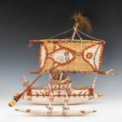 PAINTED MODEL OUTRIGGER CANOE, Papua New Guinea, with rattan platform, steering oar, side float