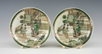 PAIR OF CHINESE FAMILLE VERTE PORCELAIN SAUCERS, similarly painted with scenes of figures on