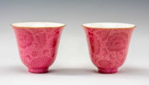 PAIR OF CHINESE PINK GLAZED WINE CUPS, four-character Qianlong marks, incised with flowering