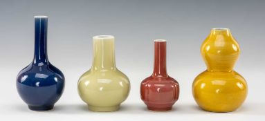 FOUR CHINESE MONOCHROME PORCELAIN VASES, comprising a blue glazed bottle vase 14.5cms (h), peach