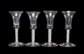 FOUR OPAQUE TWIST WINE GLASSES, late 18th century, with trumpet shaped bowl inset with bubbles at