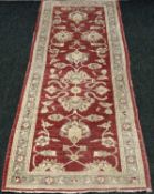 ZIEGLER TYPE WOOL RUNNER (FFRITH), red ground with all over floral motif, 254 x 90cms Provenance: