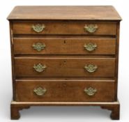 19TH CENTURY MAHOGANY DWARF CHEST of four long graduated drawers, brass drop handles and pierced