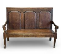 GEORGE III OAK SETTLE, c. 1780-1800, fielded three-panel back, later solid seat, raised on turned
