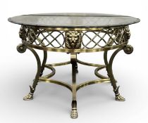 CONTEMPORARY OVAL BRASS-FRAMED COFFEE TABLE, pierced and with mask head mounts, scrolled supports