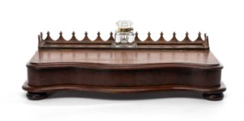 VICTORIAN MAHOGANY SERPENTINE FRONT INK STAND, supporting a heavy cut glass inkwell, 57.5 (w) x