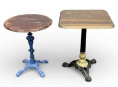 TWO VICTORIAN CAST IRON PUB TABLES, blue painted base with stained circular top, 71 (h) x 58cms (
