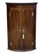 ANTIQUE MAHOGANY BOW-FRONT CORNER CUPBOARD, two doors, wall hanging, 106 (h) x 70 (w) x 50cms (d)