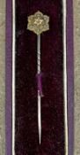 15CT GOLD STICK PIN, of flower head design, set with a small central diamond, 1.1g, in original case