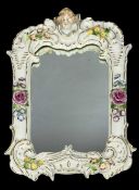 CONTINENTAL PORCELAIN FRAMED MIRROR, mid-20th century, with cherub head surmount and floral