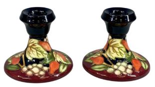 PAIR OF MOORCROFT CANDLE HOLDERS, Winter Harvest pattern, 9cms (h), boxed Provenance: private