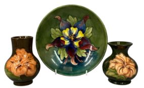 MOORCROFT COLUMBINE PATTERN CIRCULAR FOOTED BOWL, 18.5cms (diam.); and two pink magnolia vases,