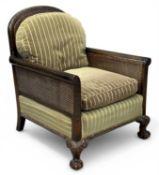 MAHOGANY FRAMED BERGÈRE ARMCHAIR, caned back and armrests, on carved claw and ball frontal supports,