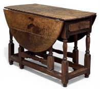 EARLY 19TH CENTURY OAK OVAL-TOP GATELEG TABLE, with single drawer, 77 (h) x 53/134 (w) x 111cms (