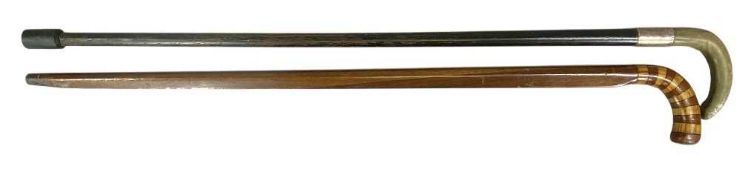 EBONISED WALKING STICK with horn handle and silver collar, and a mahogany walking stick with