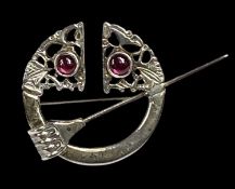 CONTINENTAL WHITE METAL PENANNULAR BROOCH / KILT PIN, of Celtic design, set with two purple cabochon
