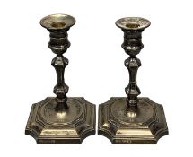 PAIR OF ELIZABETH II SILVER CANDLESTICKS, of Queen Anne form, square stepped bases with re-entrant