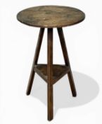 CHARACTERFUL OAK CIRCULAR-TOPPED CRICKET TABLE, with lower shelf, 19th century, 74 (h) x 49cms (