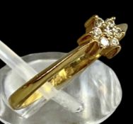 GOLD DIAMOND CLUSTER RING, set with seven small diamonds, stamped '750', size N, 2.3g Provenance: