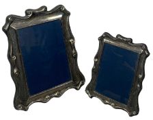 MODERN SILVER-FACED PHOTOGRAPH FRAME, with scroll decoration, 26 x 21cms; and a similar smaller