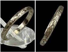 TWO WHITE METAL RINGS with chased design, one stamped 'Plat', 6.5g Provenance: private collection