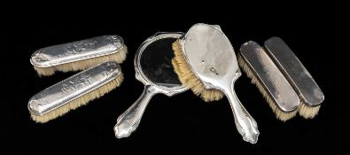 SILVER BACK DRESSING TABLE ACCESSORIES, comprising two pairs of clothes brushes, one pair embossed