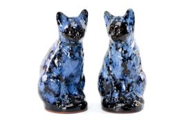TWO EWENNY SEATED POTTERY FIRESIDE CATS, inscribed to base 'Ewenny Pottery Wales', mottled blue &