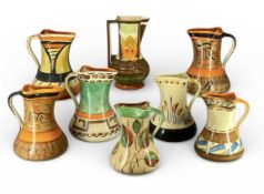 EIGHT MYOTT, SON & CO. ART DECO COLOURFUL HAND-PAINTED JUGS, various designs, 22cms (h) the