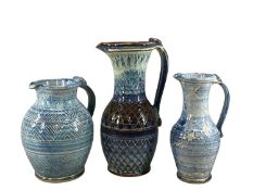 ANVIL POTTERY, three large blue glazed jugs with incised decoration, 38cms (h) the larger