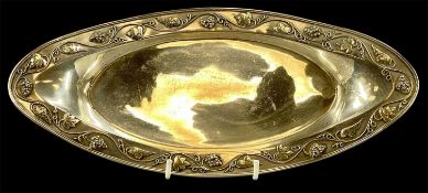 LIBERTY & CO. EDWARDIAN OVAL SILVER DISH, with a border of grape and vine leaf, on four bun feet,