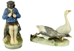 ROYAL COPENHAGEN FIGURE OF A BOY WHITTLING A STICK, and figure of two geese Provenance: private