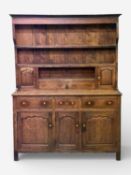 18th CENTURY OAK WELSH DRESSER, three shelf rack with two small cupboard doors and drawers, the base