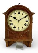 EDWARDIAN OAK-CASED WALL CLOCK with arched top, circular cream enamel dial signed 'C.E. Court, St.