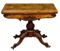VICTORIAN WALNUT FOLD-OUT GAMES TABLE, on a quad scrolled pedestal base, 72 (h) x 91 (w) x 45.
