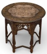 EARLY 20TH CENTURY EASTERN CARVED HARDWOOD FOLDING TABLE, with copper top inserts, 58 (h) x 64cms (