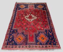 QASHQAI STYLE RUG, stepped madder field on blue ground with hooked medalions and stylised animals,