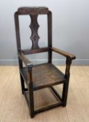 LARGE CARVED STAINED-OAK ARMCHAIR, open arms, panelled seat, shallow chameleon carvings to crest