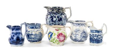SIX SWANSEA CAMBRIAN POTTERY JUGS, patterns including 'Whampoa', flow blue 'Cuba', 'Ladies with Bird