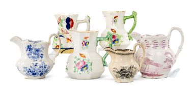 SIX CAMBRIAN POTTERY JUGS, three painted with flowers, one in pink lustre, two flower printed,