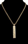 9CT GOLD LOG-FORM PENDANT with pronounced hallmark London 1978, 5.5cms, suspended from a 9ct gold