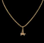 9CT GOLD OIL RIG CHARM, suspended from a 9ct gold rope-twist necklace, 75cms (l), 27.3g