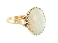 OPAL RING IN 18CT GOLD, the cabochon opal approx. 14 x 10mms, claw mounted on triform shoulders,